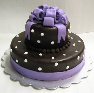 hat shaped cake, white-spotted black top with purple bottom and bow