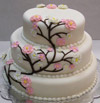 3 tier wedding cake with espalier style flowering plant