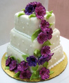 3 tier wedding cake with flowing violet flowers