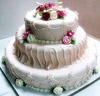 3 tier wedding cake with variously shaped fondant